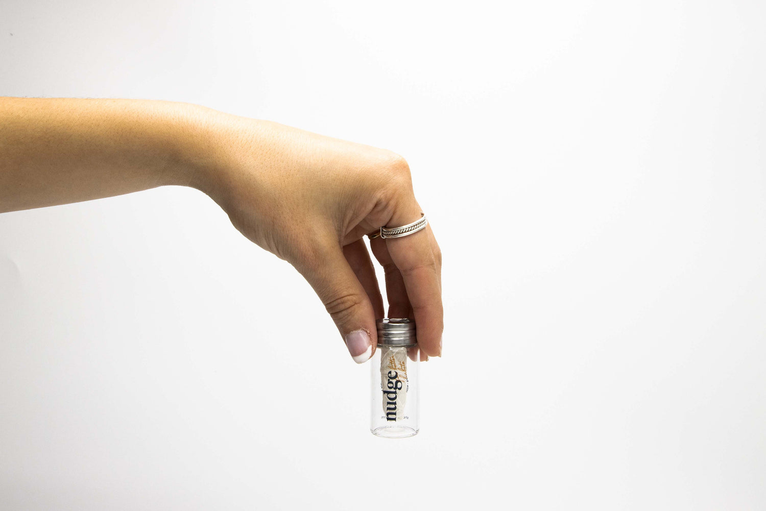 Hand holding a floss bottle