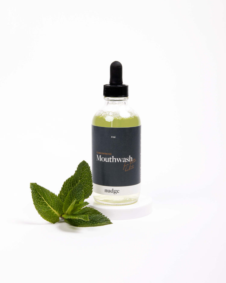 Bottle of alcohol-free mouthwash with mint leaf